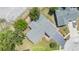 Birds-eye view of a gray roofed single-story home with a two car garage and landscaping in a residential area at 4228 Belle Isle Ct, New Port Richey, FL 34653