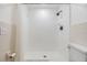 Bright walk-in shower with white tile, dark fixtures, and a white shower curtain at 4228 Belle Isle Ct, New Port Richey, FL 34653