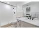 All-white bathroom with updated vanity and faucet, plus walk-in shower with black fixtures at 4228 Belle Isle Ct, New Port Richey, FL 34653