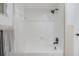 Bright bathroom includes a shower with curtain and gray towel hanging nearby at 4228 Belle Isle Ct, New Port Richey, FL 34653