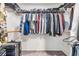 Spacious walk-in closet features metal shelving, hanging rods, and carpeted floor at 4228 Belle Isle Ct, New Port Richey, FL 34653