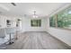 Open dining room area with large windows and modern barstool seating at 4228 Belle Isle Ct, New Port Richey, FL 34653