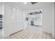 Neutral entryway with tile floors leads to the home's kitchen with white cabinetry at 4228 Belle Isle Ct, New Port Richey, FL 34653