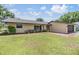 Charming single-story home featuring a well-maintained lawn, mature landscaping, and a brick-lined walkway at 4228 Belle Isle Ct, New Port Richey, FL 34653
