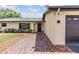 Home exterior showcasing a brick-lined walkway leading to a covered front door with sidelights at 4228 Belle Isle Ct, New Port Richey, FL 34653