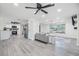 Open concept living space showcasing kitchen and living room with gray sectional sofa at 4228 Belle Isle Ct, New Port Richey, FL 34653