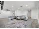Spacious living room features modern gray sectional sofa with wood grain flooring at 4228 Belle Isle Ct, New Port Richey, FL 34653