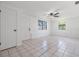 Bright living room featuring a tile floor, large windows, and a ceiling fan at 4228 Belle Isle Ct, New Port Richey, FL 34653