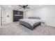 Carpeted main bedroom showcasing a black fireplace accent wall and ceiling fan at 4228 Belle Isle Ct, New Port Richey, FL 34653
