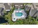 Aerial view of a sparkling community pool with lounge chairs and lush landscaping, perfect for relaxation and recreation at 4777 Duhme Rd # 1D, St Petersburg, FL 33708