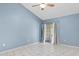 Spacious bedroom with ceiling fan, tile floor and sliding door to the backyard at 4777 Duhme Rd # 1D, St Petersburg, FL 33708