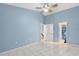 Bedroom with tile flooring, ceiling fan, and multiple access doors at 4777 Duhme Rd # 1D, St Petersburg, FL 33708