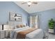 Primary bedroom boasts vaulted ceilings, accent wall, and a large sliding door to a private patio at 4777 Duhme Rd # 1D, St Petersburg, FL 33708