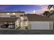 Townhouse featuring an attached garage, well-manicured landscaping, and a covered carport at 4777 Duhme Rd # 1D, St Petersburg, FL 33708