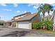 Attached garage with driveway and tropical landscaping around the exterior of the building at 4777 Duhme Rd # 1D, St Petersburg, FL 33708