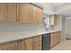 Bright kitchen features light wood cabinets, speckled countertops, stainless dishwasher, and a tile floor at 4777 Duhme Rd # 1D, St Petersburg, FL 33708