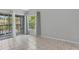 Bright living room with tile flooring and large sliding glass doors that open to a balcony, offering natural light and outdoor views at 4777 Duhme Rd # 1D, St Petersburg, FL 33708