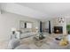Cozy living room with neutral furniture, tile floors, and a fireplace at 4777 Duhme Rd # 1D, St Petersburg, FL 33708
