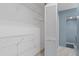 Spacious walk-in closet with wire shelving and a door leading to a bathroom, providing ample storage and convenience at 4777 Duhme Rd # 1D, St Petersburg, FL 33708