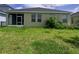 View of the backyard with a screened-in lanai and some mature landscaping at 5082 Inshore Landings Dr, Apollo Beach, FL 33572