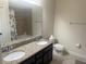 Well-lit bathroom with granite countertop, double sinks, and shower at 5082 Inshore Landings Dr, Apollo Beach, FL 33572