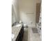 Bathroom with granite countertop, dark cabinets, tiled floors, and shower at 5082 Inshore Landings Dr, Apollo Beach, FL 33572