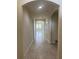 Hallway featuring an arched entry way to the home's living spaces and tile floors at 5082 Inshore Landings Dr, Apollo Beach, FL 33572
