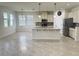 Spacious kitchen with island, stainless steel appliances, tiled floor, and granite countertops at 5082 Inshore Landings Dr, Apollo Beach, FL 33572