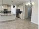 Modern kitchen with large island, stainless steel refrigerator, tiled floor, and lots of cabinet space at 5082 Inshore Landings Dr, Apollo Beach, FL 33572