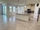 Spacious kitchen with a large island, stainless appliances, and neutral tile flooring throughout the home at 5082 Inshore Landings Dr, Apollo Beach, FL 33572