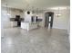Wide angle shot of a modern kitchen, stainless steel appliances, large island, and tiled flooring at 5082 Inshore Landings Dr, Apollo Beach, FL 33572