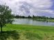 Scenic view of the lake and lush green landscaping at 5082 Inshore Landings Dr, Apollo Beach, FL 33572