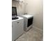 Convenient laundry room with modern washer and dryer units and storage shelf at 5082 Inshore Landings Dr, Apollo Beach, FL 33572