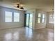 Living room featuring tile floors, large windows, and sliding glass doors to a covered patio at 5082 Inshore Landings Dr, Apollo Beach, FL 33572