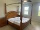 Bedroom featuring a four-poster bed, two side tables, and windows providing natural light at 5082 Inshore Landings Dr, Apollo Beach, FL 33572