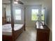 Main bedroom with four poster bed, ceiling fan and two windows at 5082 Inshore Landings Dr, Apollo Beach, FL 33572
