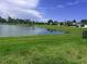 Scenic pond view with lush green surroundings and neighboring houses in a peaceful community at 5082 Inshore Landings Dr, Apollo Beach, FL 33572