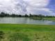 Scenic view of a pond surrounded by lush greenery and beautiful landscaping at 5082 Inshore Landings Dr, Apollo Beach, FL 33572