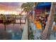 Outdoor waterfront restaurant with colorful umbrellas and views of boats docked at the marina at 5082 Inshore Landings Dr, Apollo Beach, FL 33572