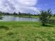 Backyard view featuring a picturesque lake and lush green landscaping on a sunny day at 5082 Inshore Landings Dr, Apollo Beach, FL 33572