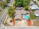 Aerial view of home with a fenced-in pool and well-maintained landscaping at 5236 Madison St, New Port Richey, FL 34652