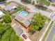 Charming home with a fenced backyard featuring a private in-ground pool, landscaping, and a detached garage at 5236 Madison St, New Port Richey, FL 34652