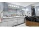 Well-lit bathroom featuring dual sinks with marble countertops and modern vanity lighting at 5236 Madison St, New Port Richey, FL 34652