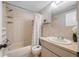 Functional bathroom featuring a shower-tub combo and vanity with a neutral color scheme at 5236 Madison St, New Port Richey, FL 34652