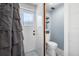 Bathroom featuring a toilet and shower with tiled walls and glass door at 5236 Madison St, New Port Richey, FL 34652