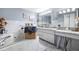 Bright bathroom with a soaking tub, marble countertops, dual sinks, and vanity lighting at 5236 Madison St, New Port Richey, FL 34652