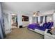 A comfortable bedroom featuring a walk-in closet, TV, and a plush purple comforter on the bed at 5236 Madison St, New Port Richey, FL 34652