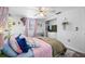 Comfortable bedroom featuring a soft bed, a vanity with a TV, and natural lighting at 5236 Madison St, New Port Richey, FL 34652