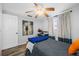 Well-lit bedroom with wood-look flooring, neutral walls, and ample natural light from the window at 5236 Madison St, New Port Richey, FL 34652