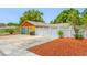 Spacious driveway with a detached garage and white privacy fence, offering ample parking at 5236 Madison St, New Port Richey, FL 34652